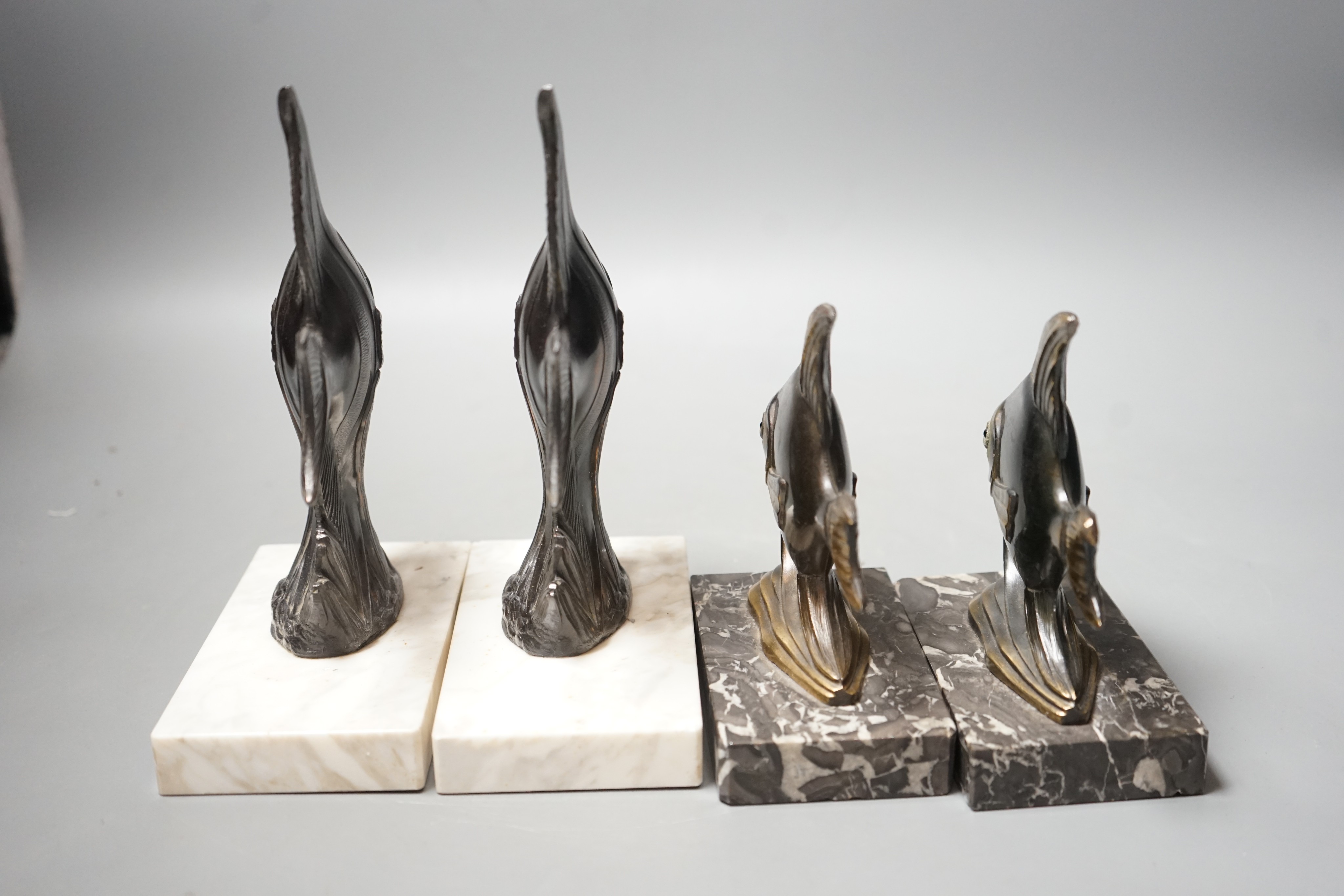 Two pairs of Art Deco spelter 'Angel fish' bookends. Tallest pair 20cm